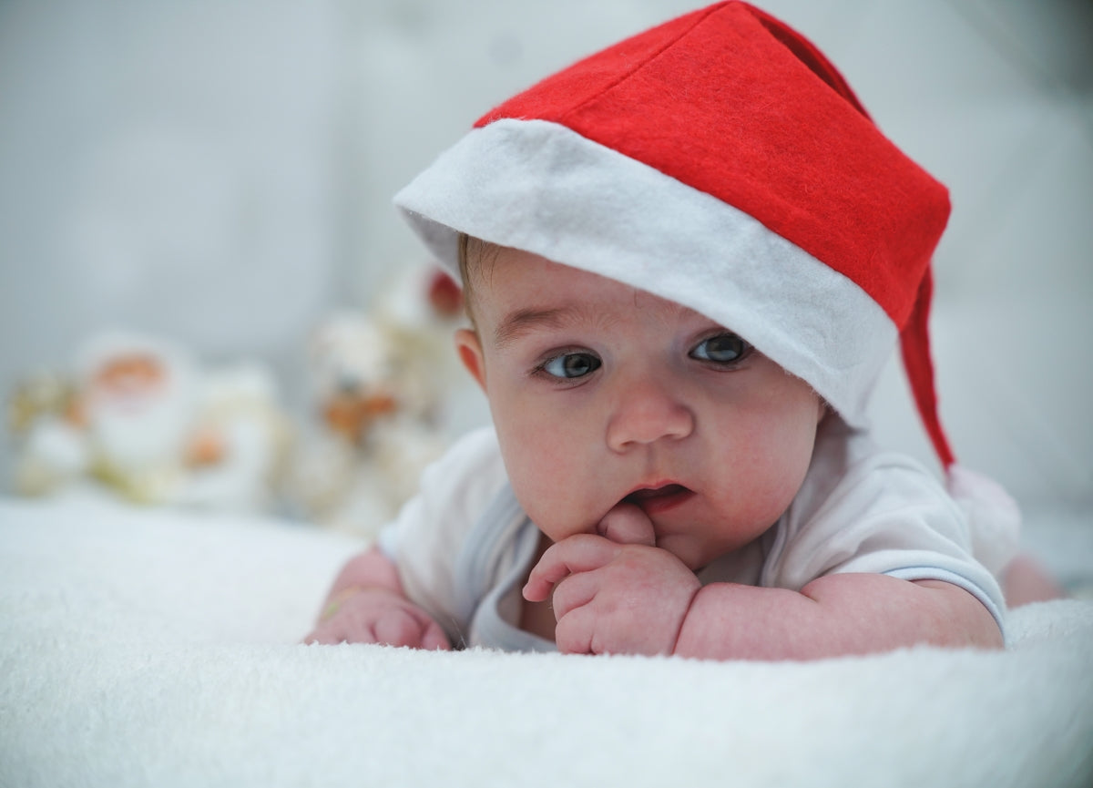 baby in white and red santa hat