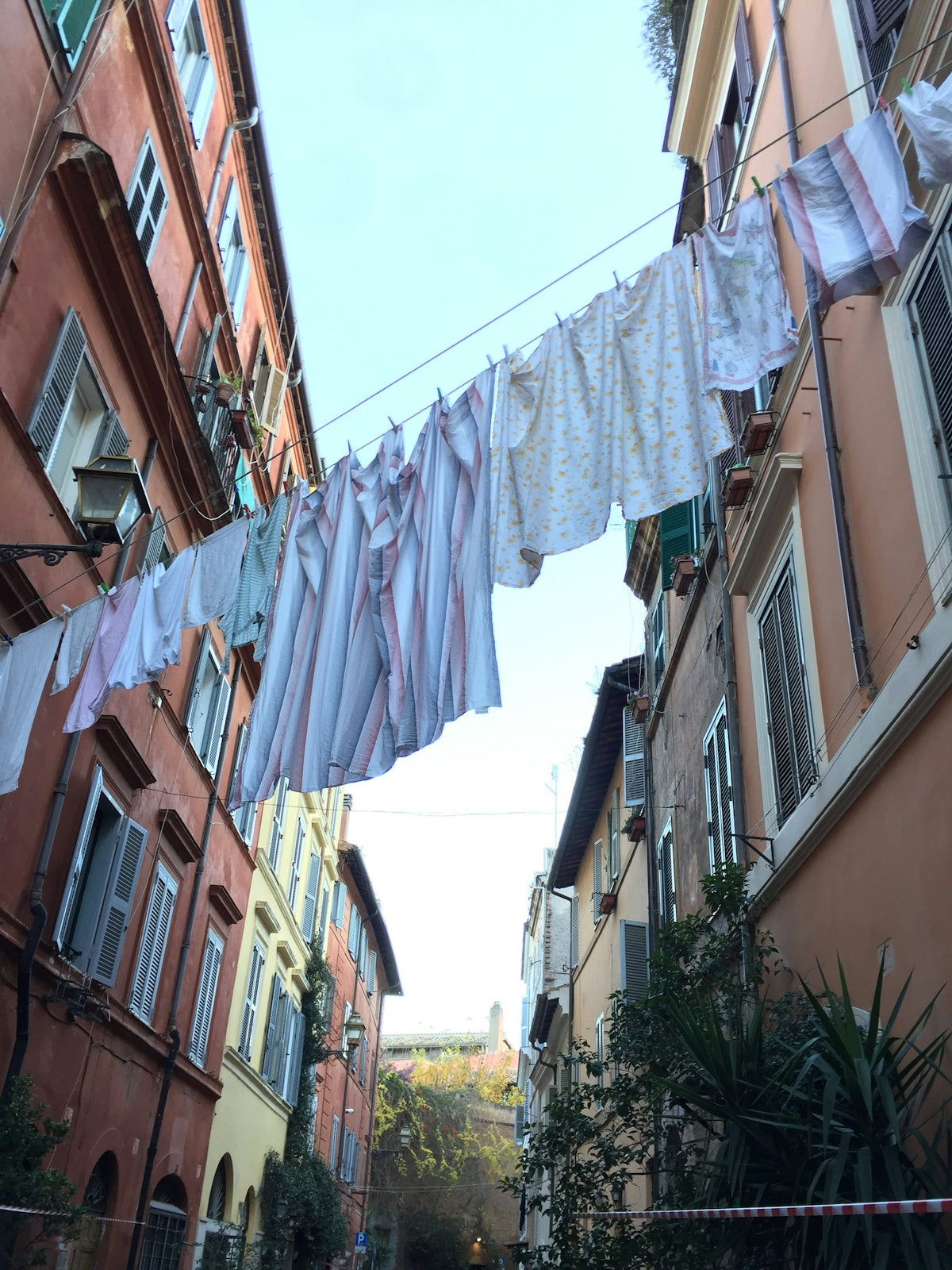 clothes hanging on a clothes line outside of a building