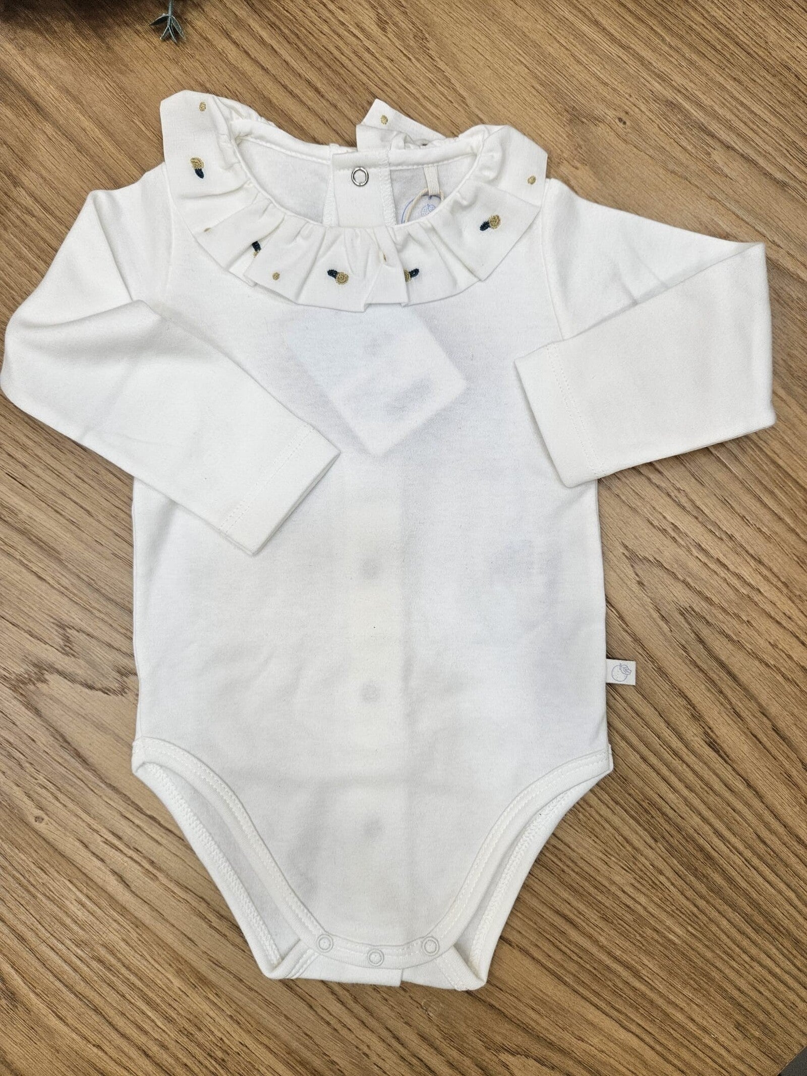 Body con colletto a volant con ricamo di fiorellini